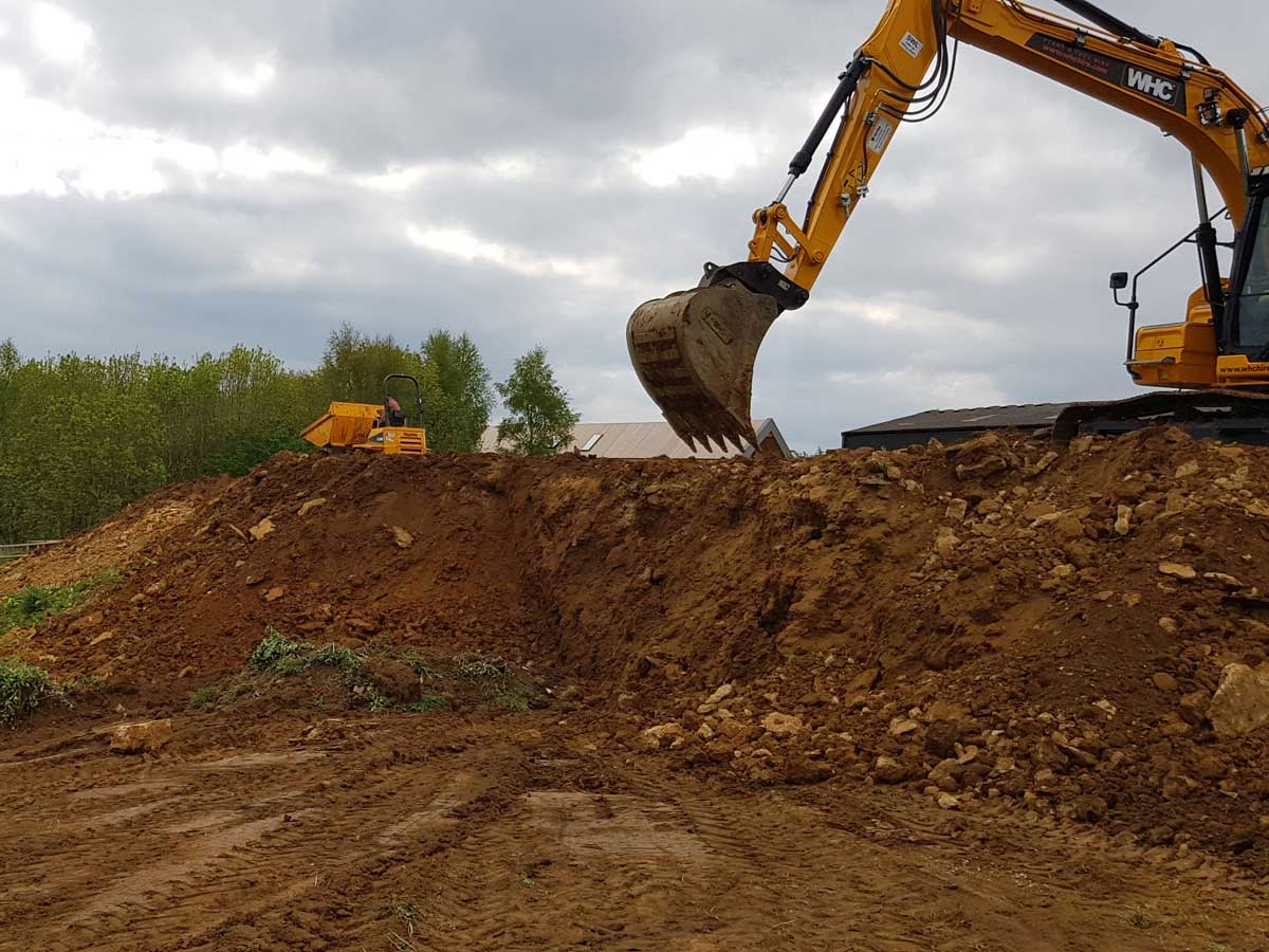 using JCB JCX and mini digger to create bank